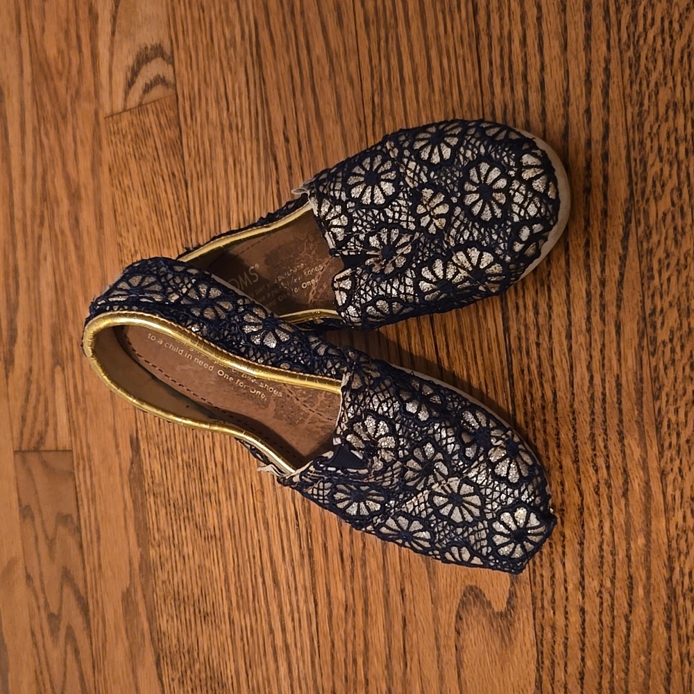 Toms gold and navy glitter crochet slip ons